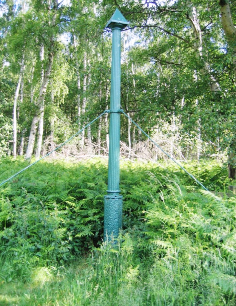 The Holme Fen Post was installed with its top close to ground level. The exposed column records how far the surrounding peat has sunk since nineteenth-century drainage.
