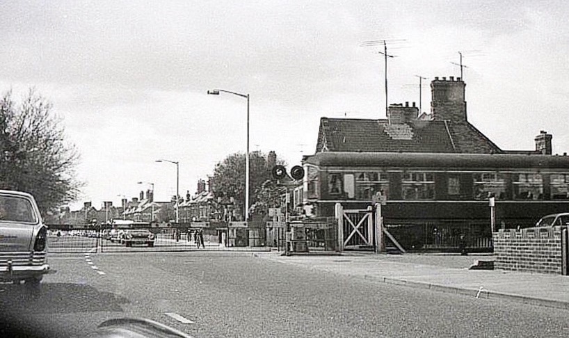 The train from Hunstanton to King's Lynn at the Gaywood Road / Lynn Road Crossing