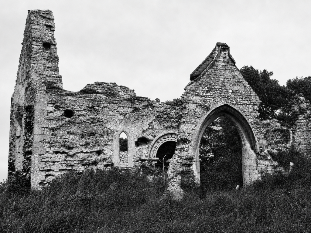 Mintlyn, St Michael. View from the south, c. 1935; the porch and the south doorway have since collapsed. 
B37/608 copyright Royal Commission on Historical Monuments (England).