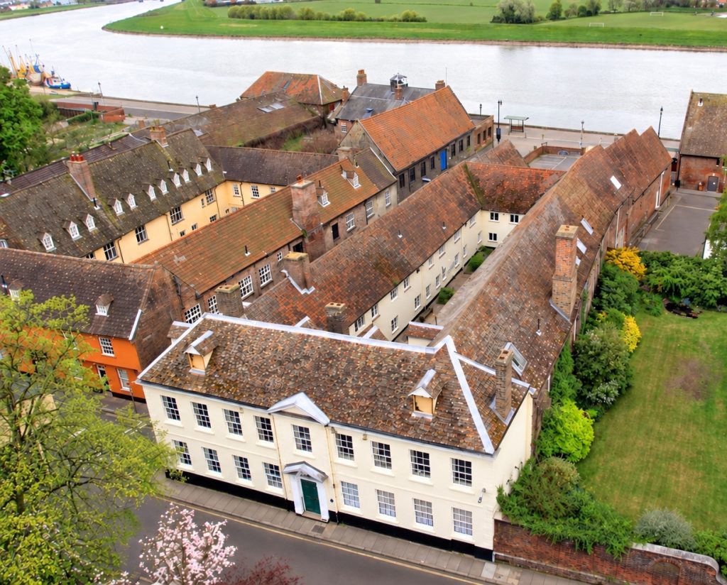 King's Lynn's Hanse House (with Hampton Court to the left). 
AI improved image. Source: Paul Richards https://www.spab.org.uk/news/building-focus-hanse-house-kings-lynn