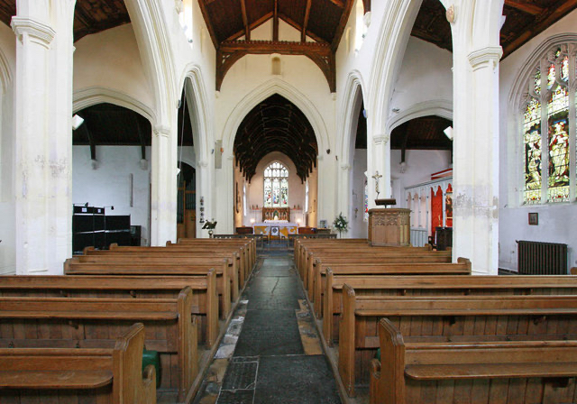 The interior looking east. The medieval nave roof contrasts with the nineteenth-century roof over the chancel. Photograph: John Salmon.