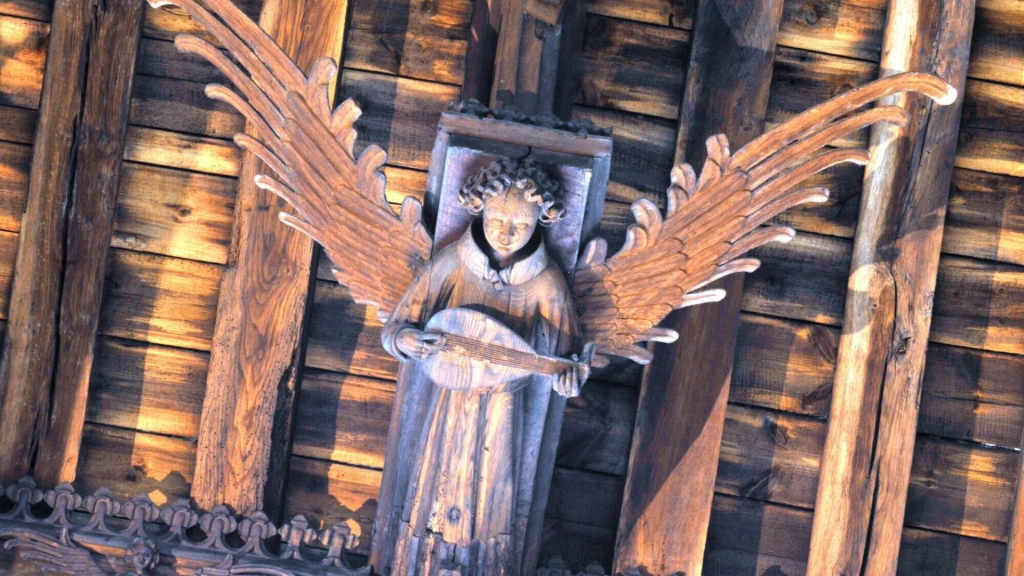  One of the carved roof angels of St Nicholas’ Chapel. The roof contains twenty-four principal angels, with some playing instruments and others holding religious symbols.
Source: https://www.visitchurches.org.uk/